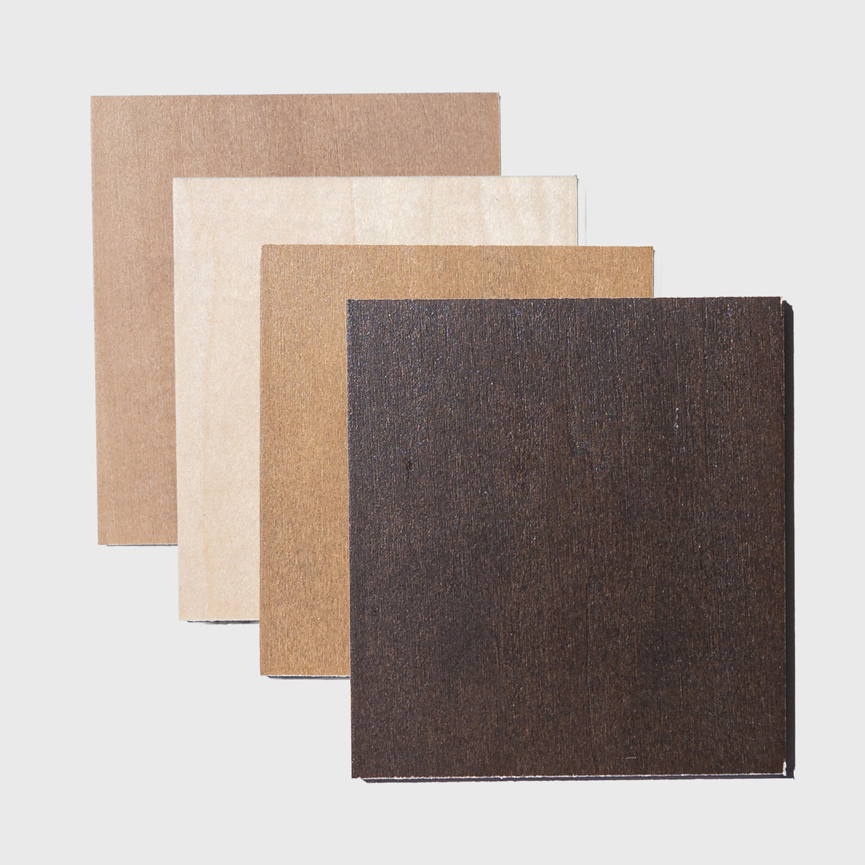 Four wood swatches in different colors on a light gray background