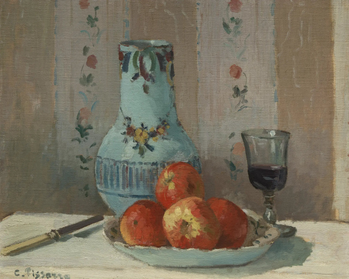 apples neatly displayed on a table near a vase