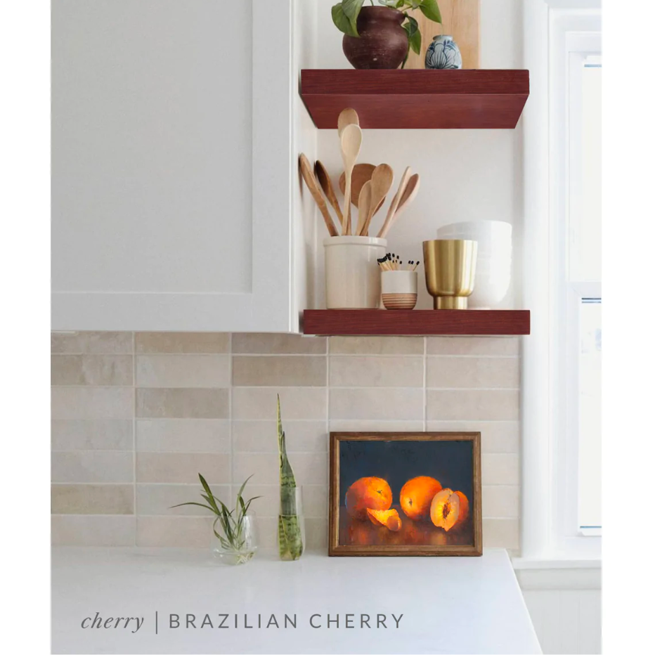 cherry floating shelves in a kitchen with the Brazilian cherry finish applied decorated with kitchen utensils, a plant, charcuterie board, and vases