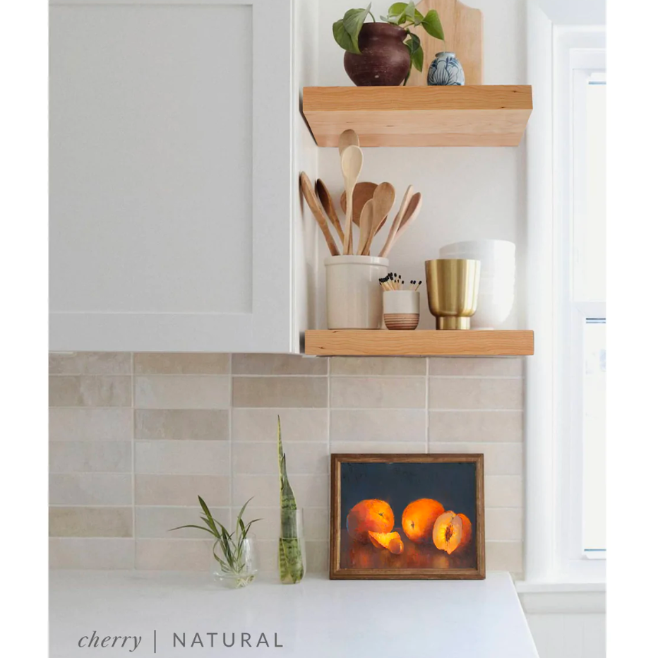 cherry floating shelves in a kitchen with the natural finish applied decorated with kitchen utensils, a plant, charcuterie board, and vases