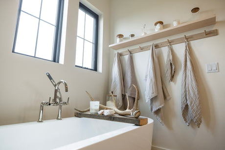 An organized and functional bathroom with floating shelves.