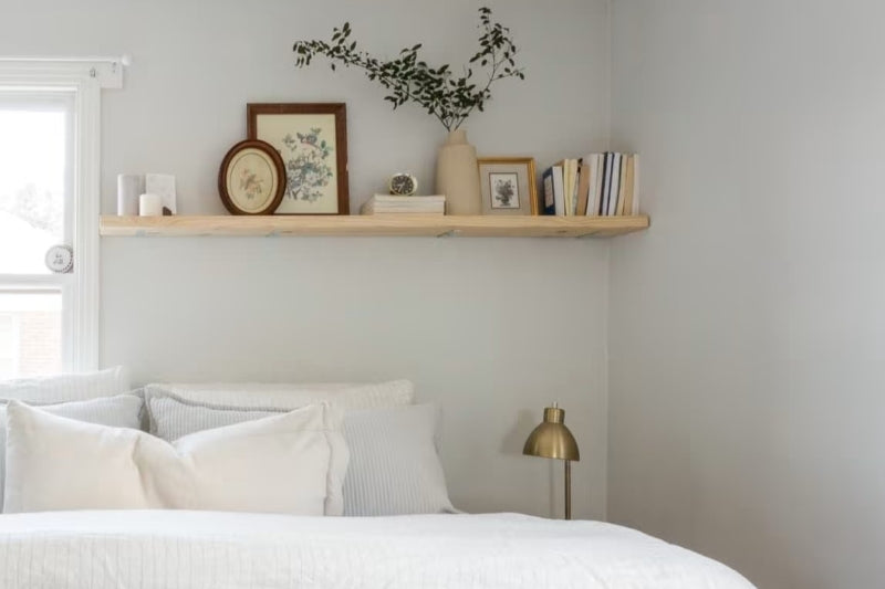 A custom floating shelf above the bed