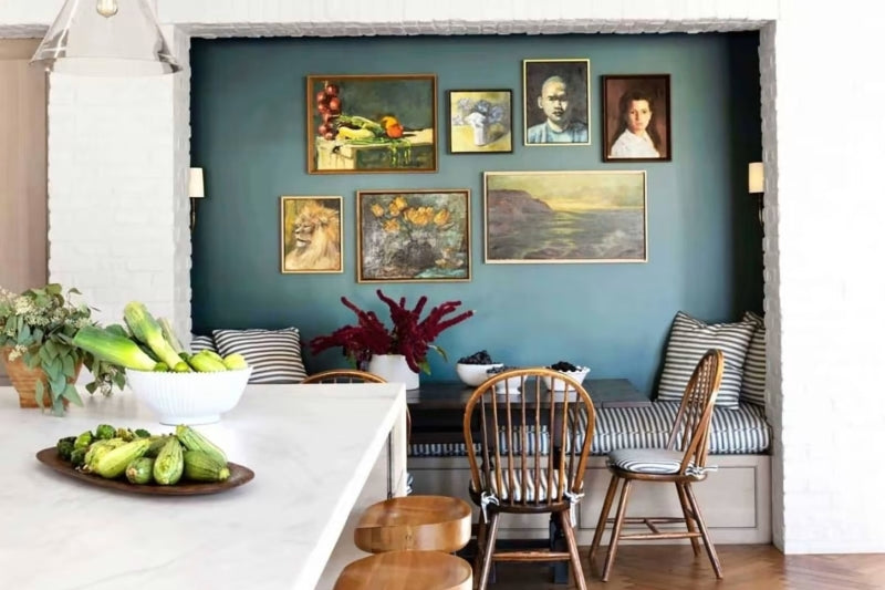 A blue accent wall with various picture frames